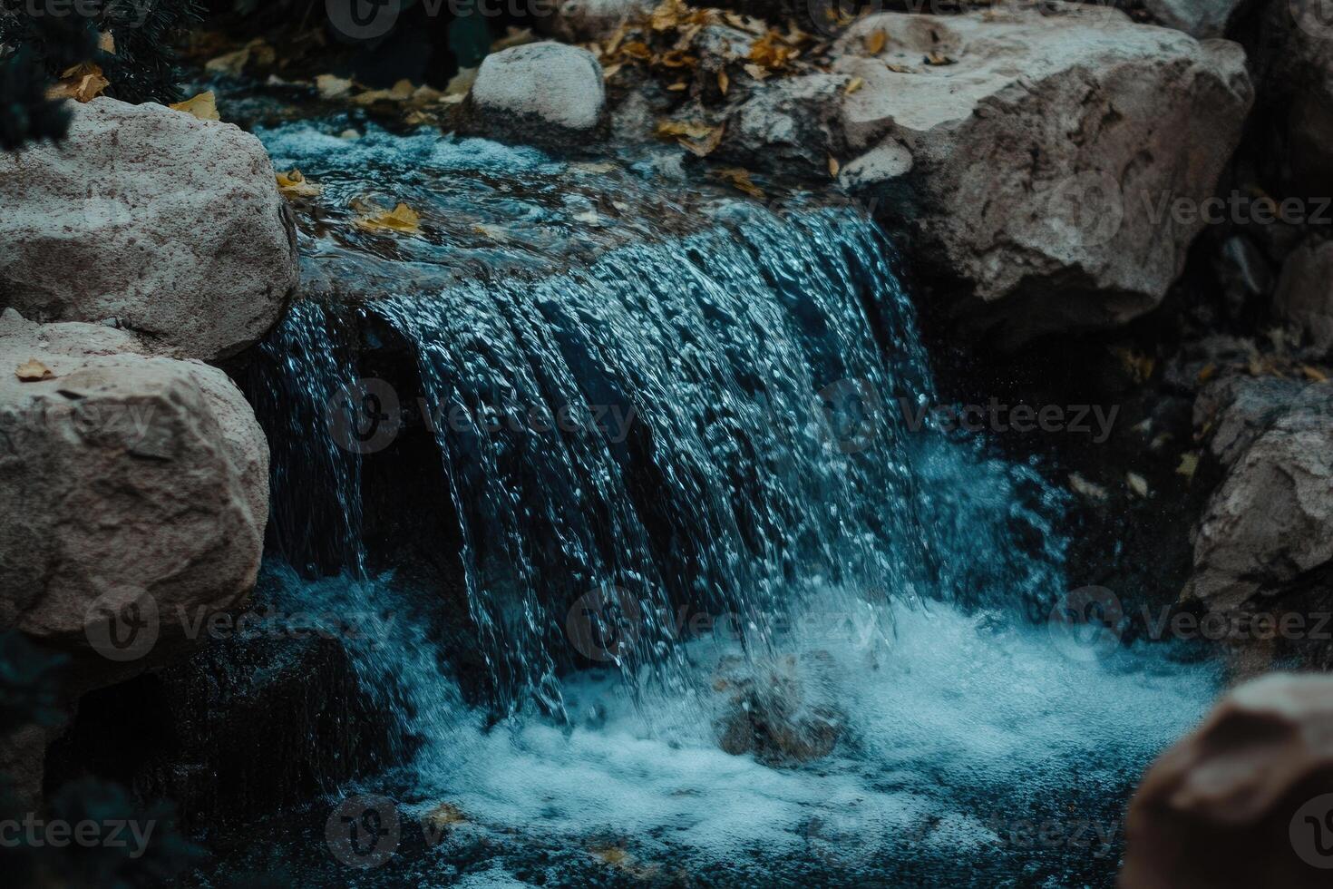 Cascading water over rocks in a small stream photo