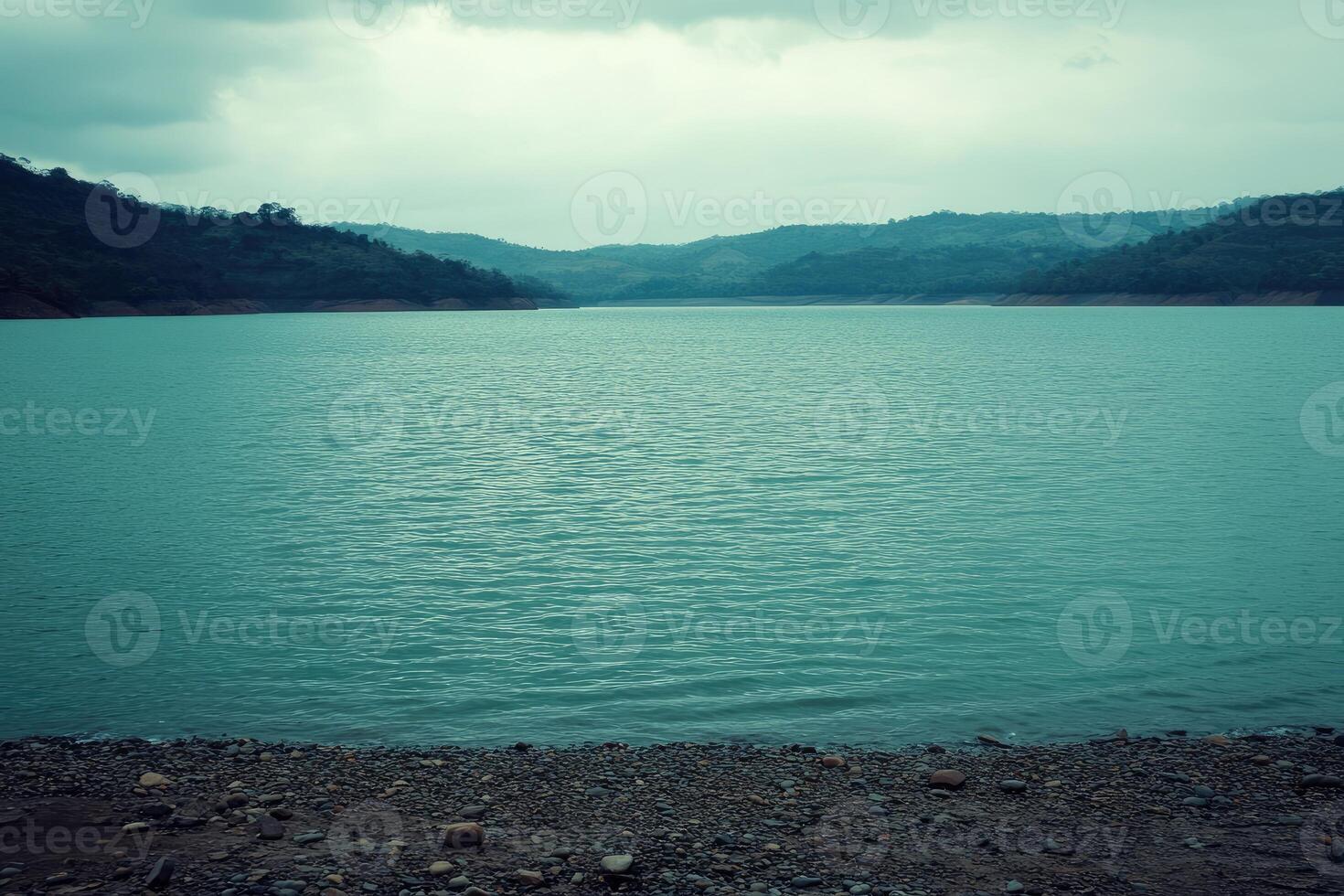 Calm reservoir reflecting a cloudy sky photo