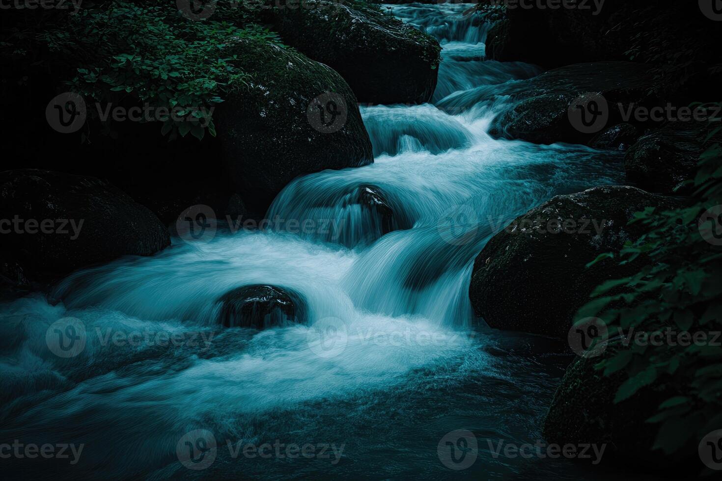 Water cascading over rocks in a serene forest stream photo