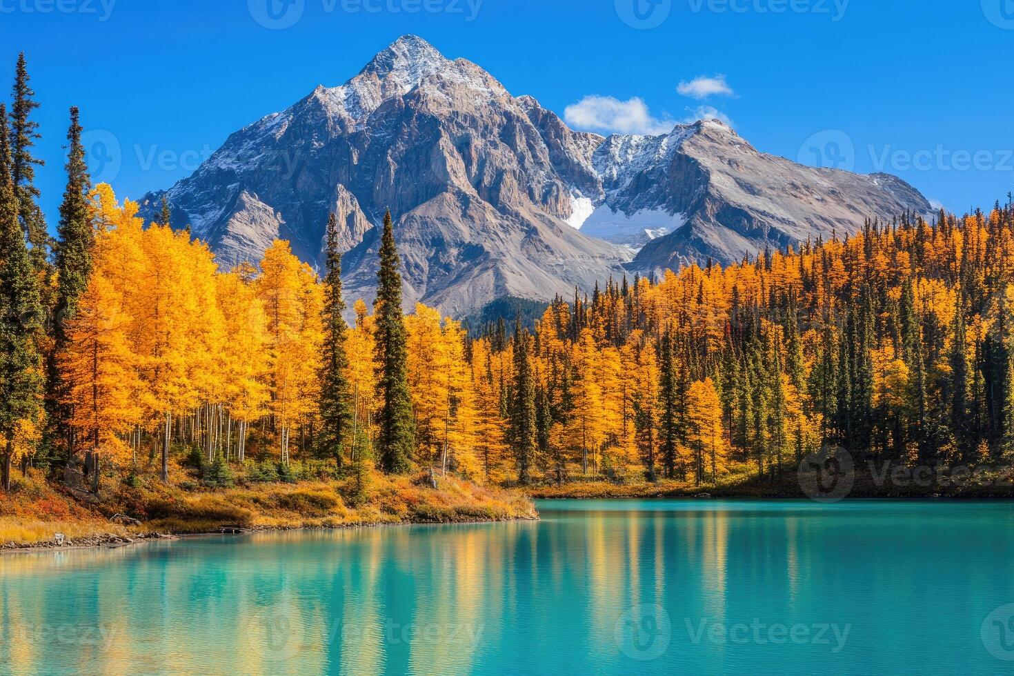A lake surrounded by trees and mountains in the fall photo