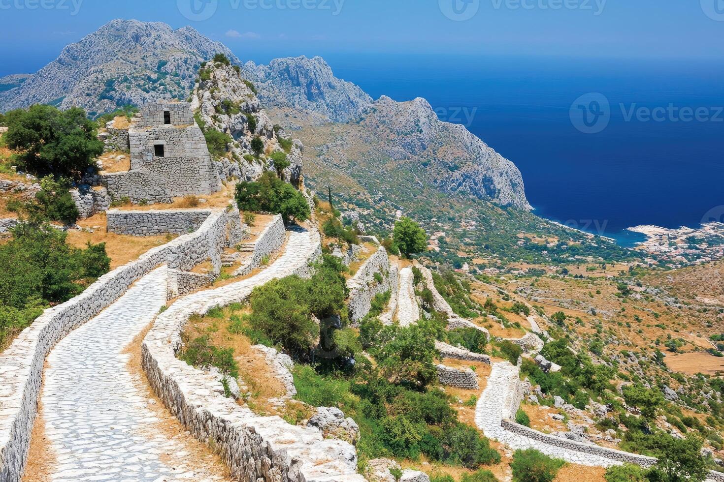 Ancient pathways winding through mountainous terrain overlooking a coastal vista 66462217 Stock Photo at Vecteezy