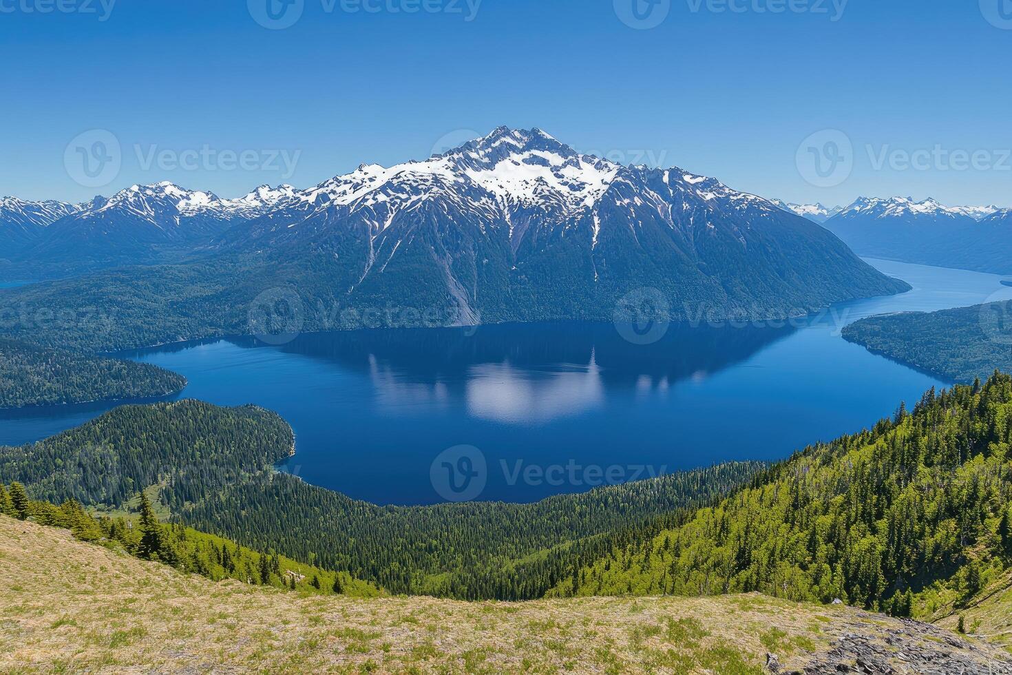 Alpine lake nestled among snow-capped peaks photo