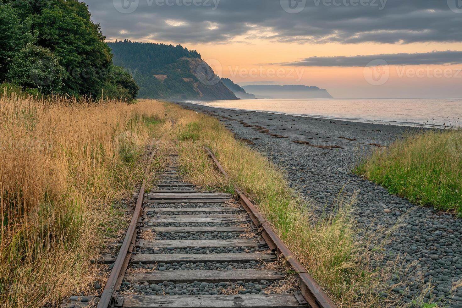 Abandoned railway track leads to a beach at dawn photo