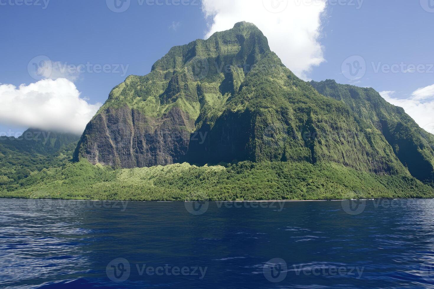 Lush island peak rising above turquoise water photo