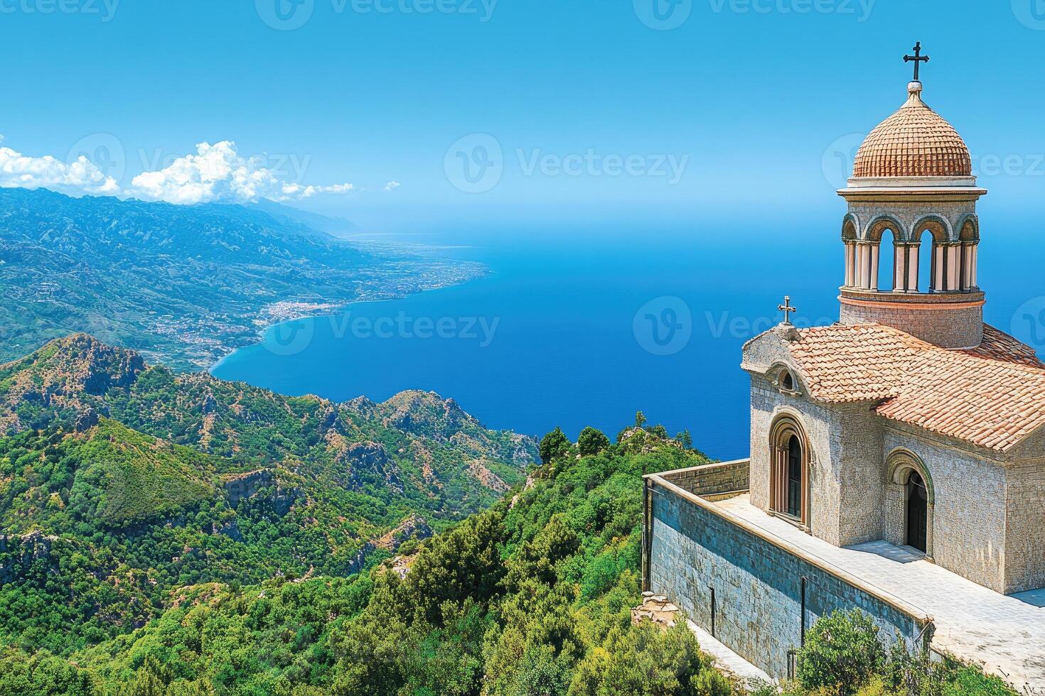 Coastal Chapel perched atop a mountain range, overlooking a turquoise sea. Lush greenery surrounding a small, light-brown stone chapel, with a terracotta dome and a backdrop of dramatic mountains and clear blue waters photo