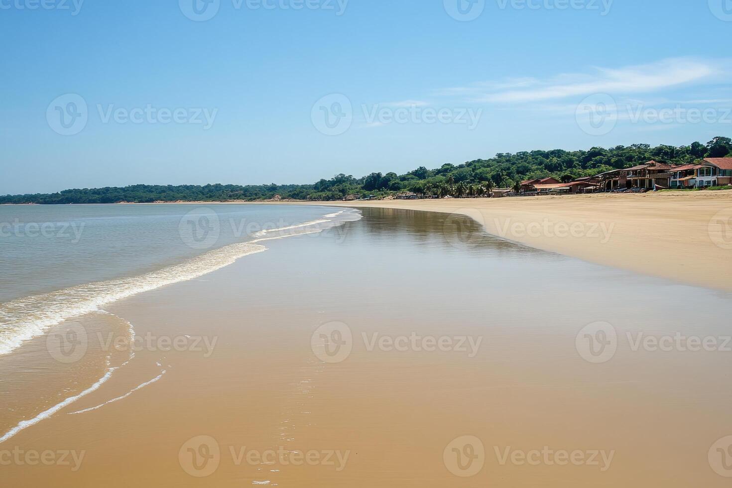 Tranquil beach scene with calm waves and coastal buildings photo