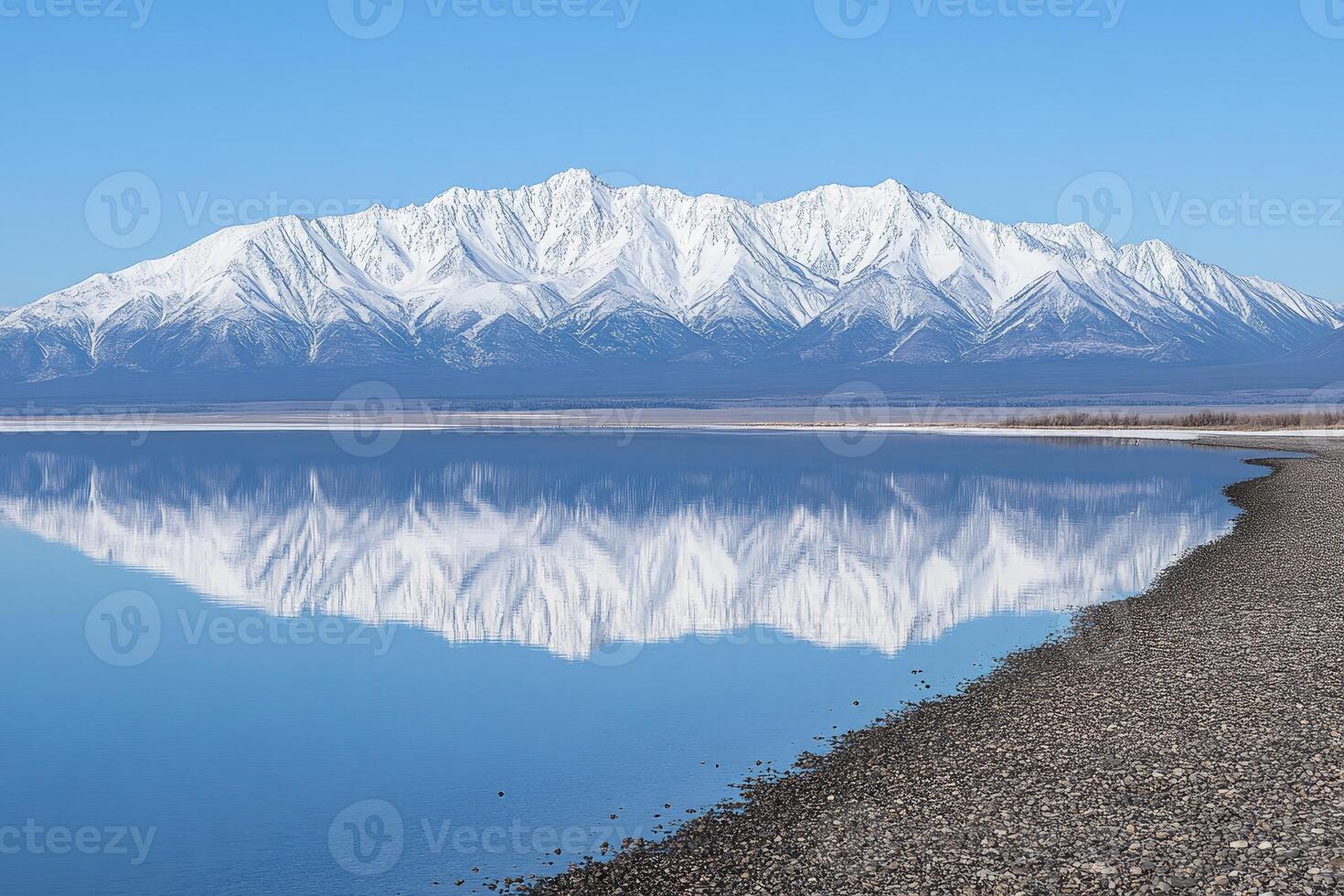 A tranquil lake reflecting snow-capped mountains. A serene alpine vista photo