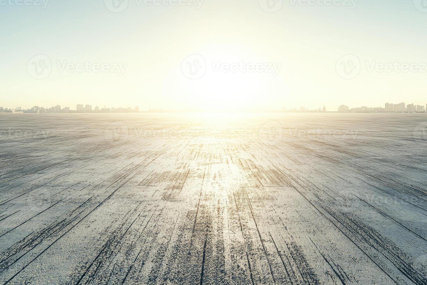 Empty paved road stretching towards a city skyline photo