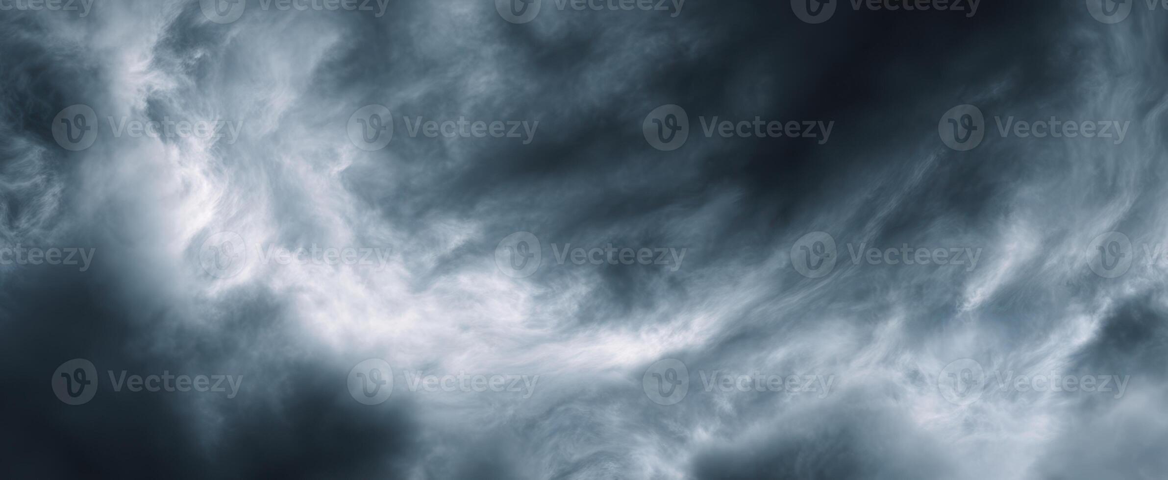 The dark and swirling clouds creating a dramatic sky atmosphere. photo