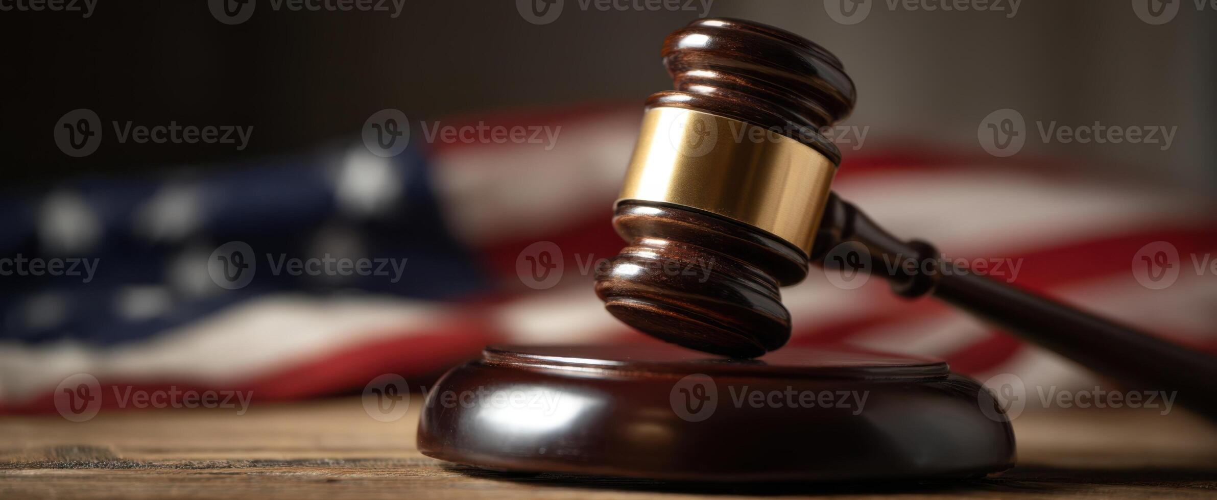 The gavel symbolizing justice on a wooden surface with an American flag. photo