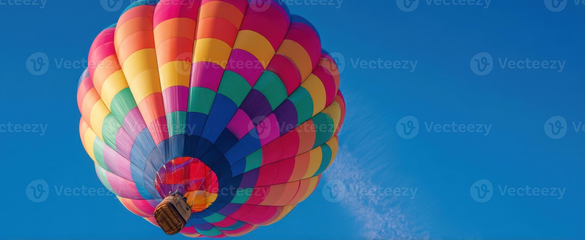 The colorful hot air balloon soaring in the clear blue sky. photo