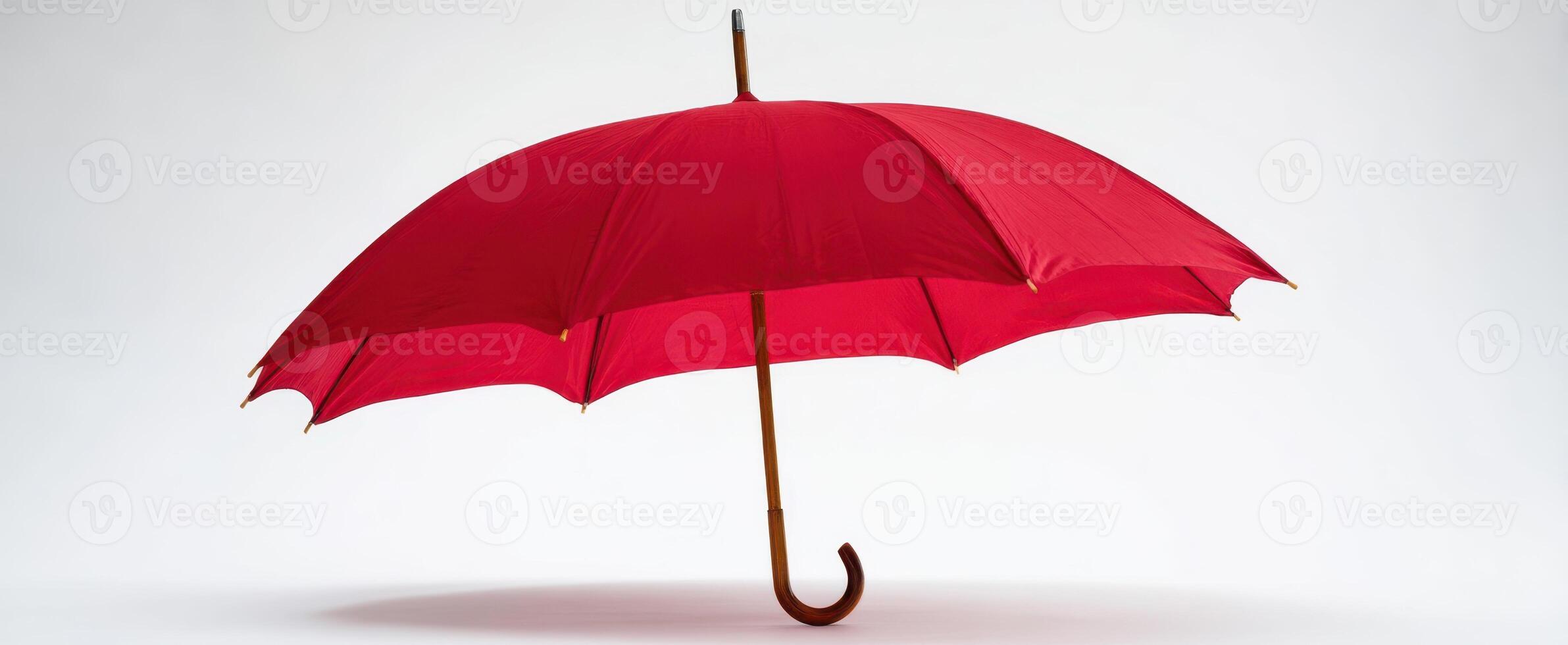 The elegant red umbrella standing proudly against a minimalistic backdrop. photo