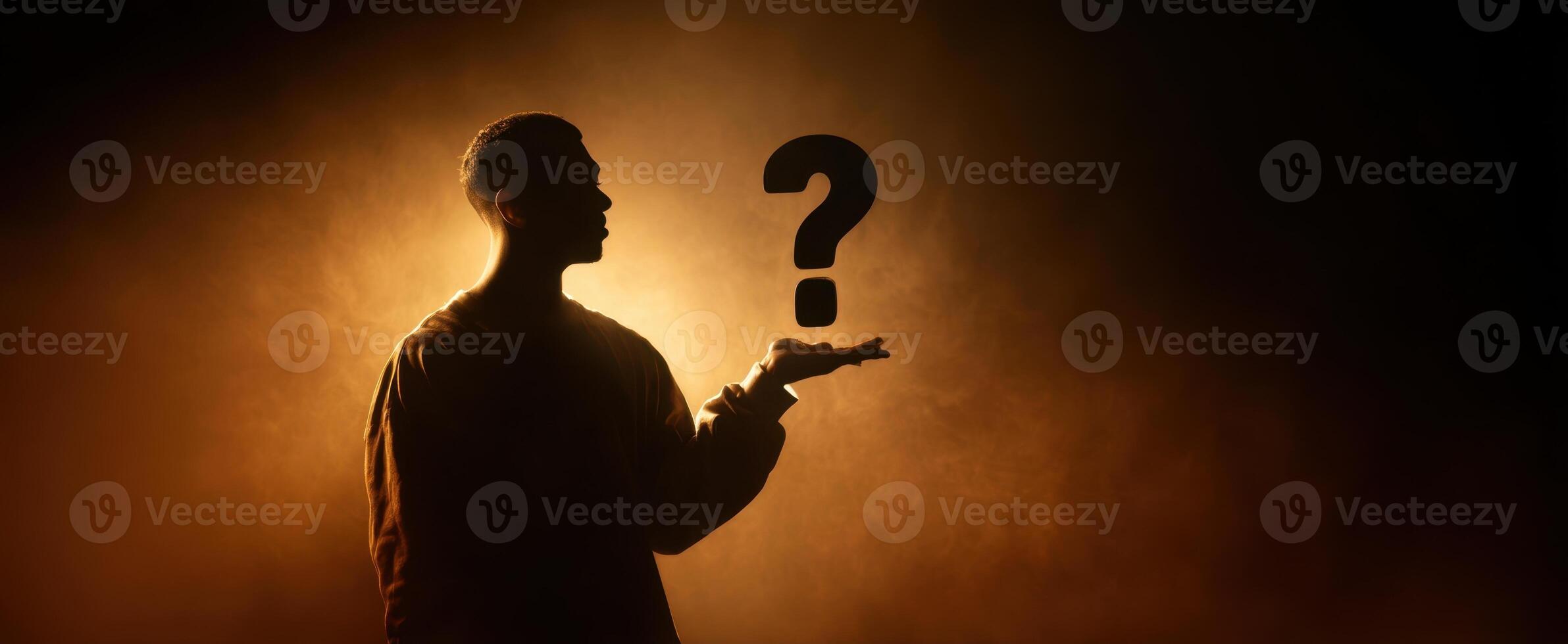 The silhouette of a person pondering life's mysterious questions against a glowing background. photo