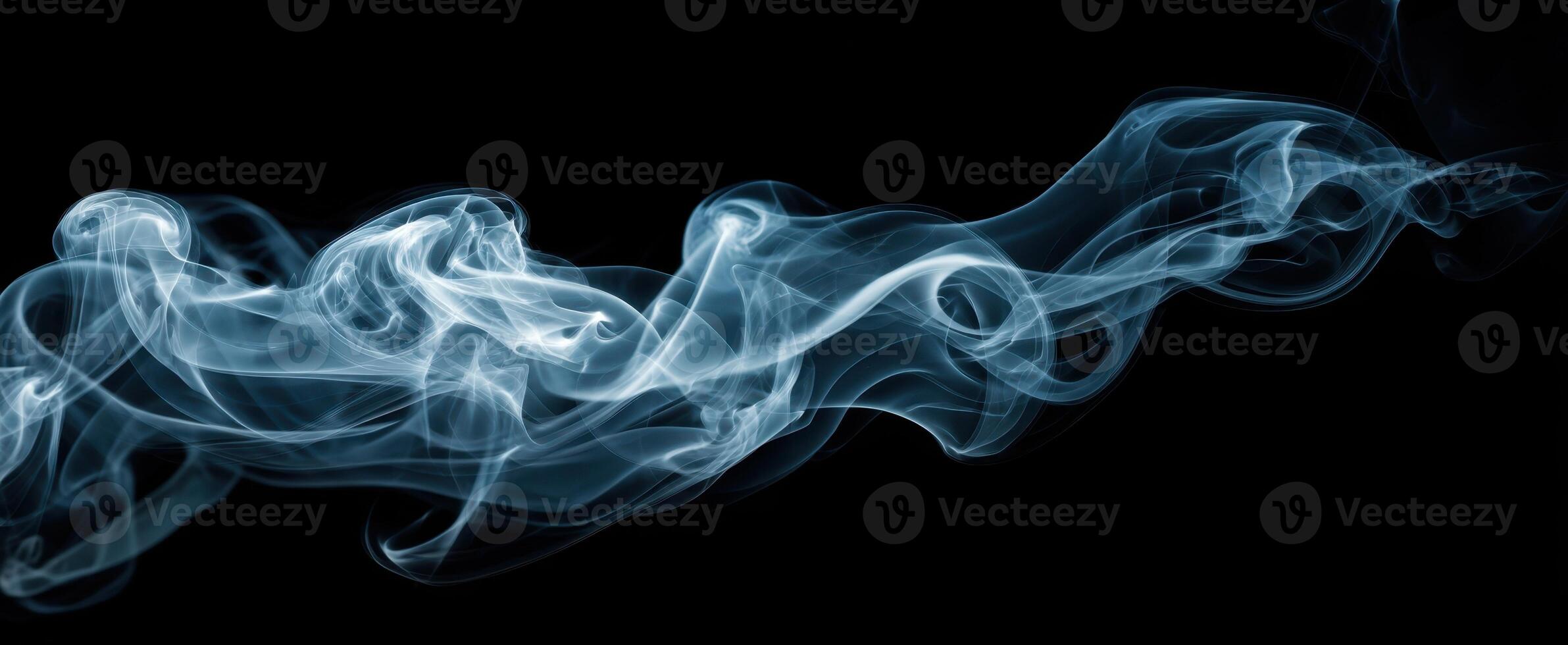 The graceful dance of smoke swirling against a dark backdrop photo