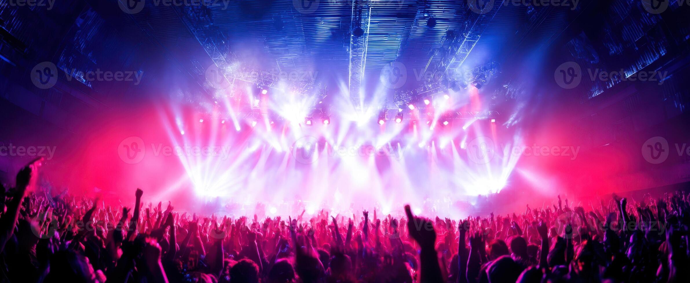 The vibrant concert scene filled with enthusiastic fans and dazzling lights. photo