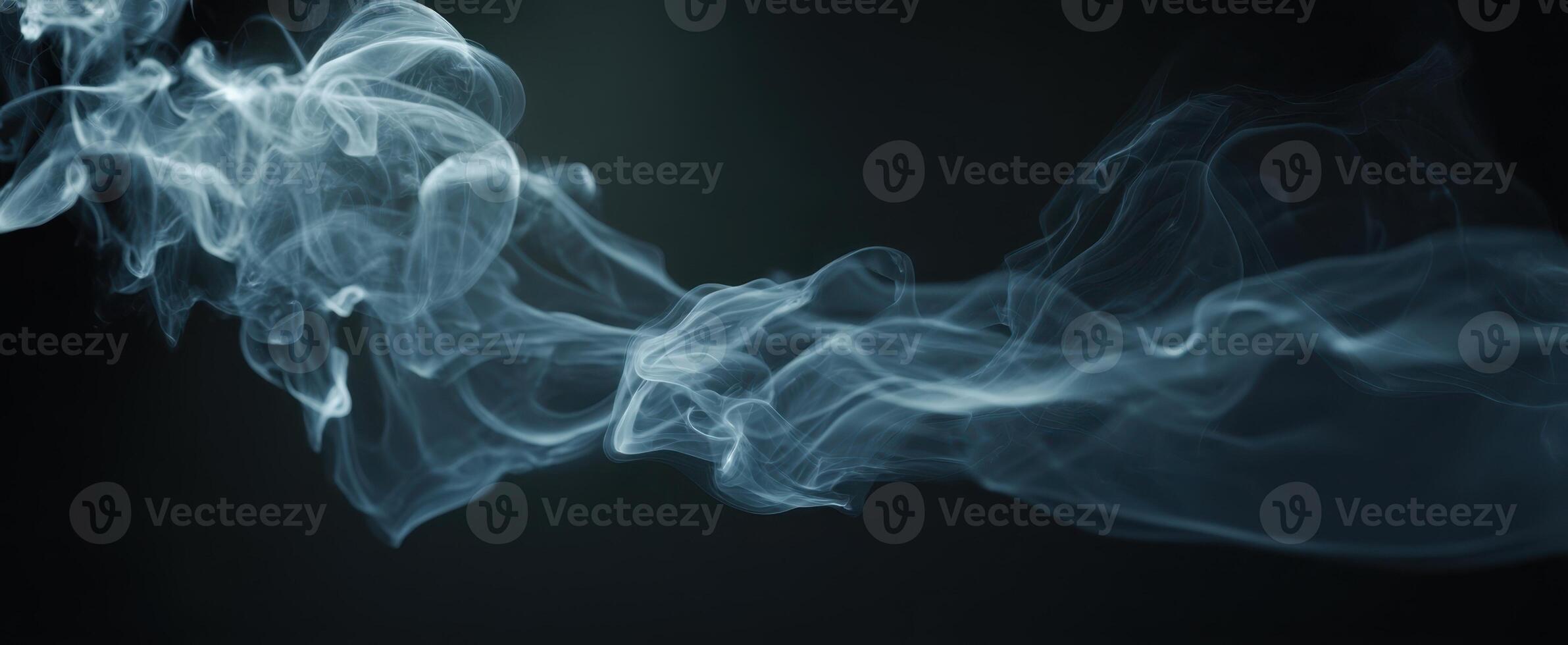 The graceful movement of smoke creating an ethereal and mysterious atmosphere. photo