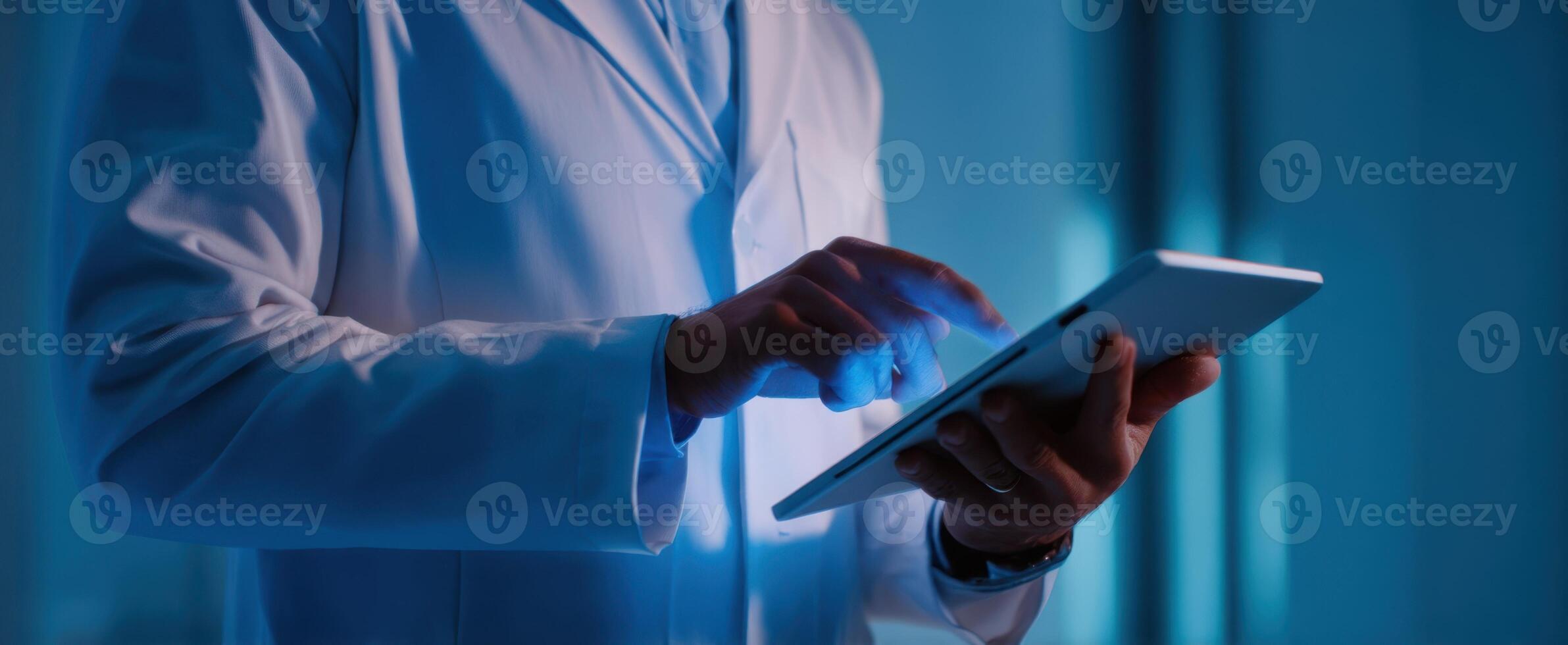 The doctor using a tablet in a modern healthcare setting for patient management. photo