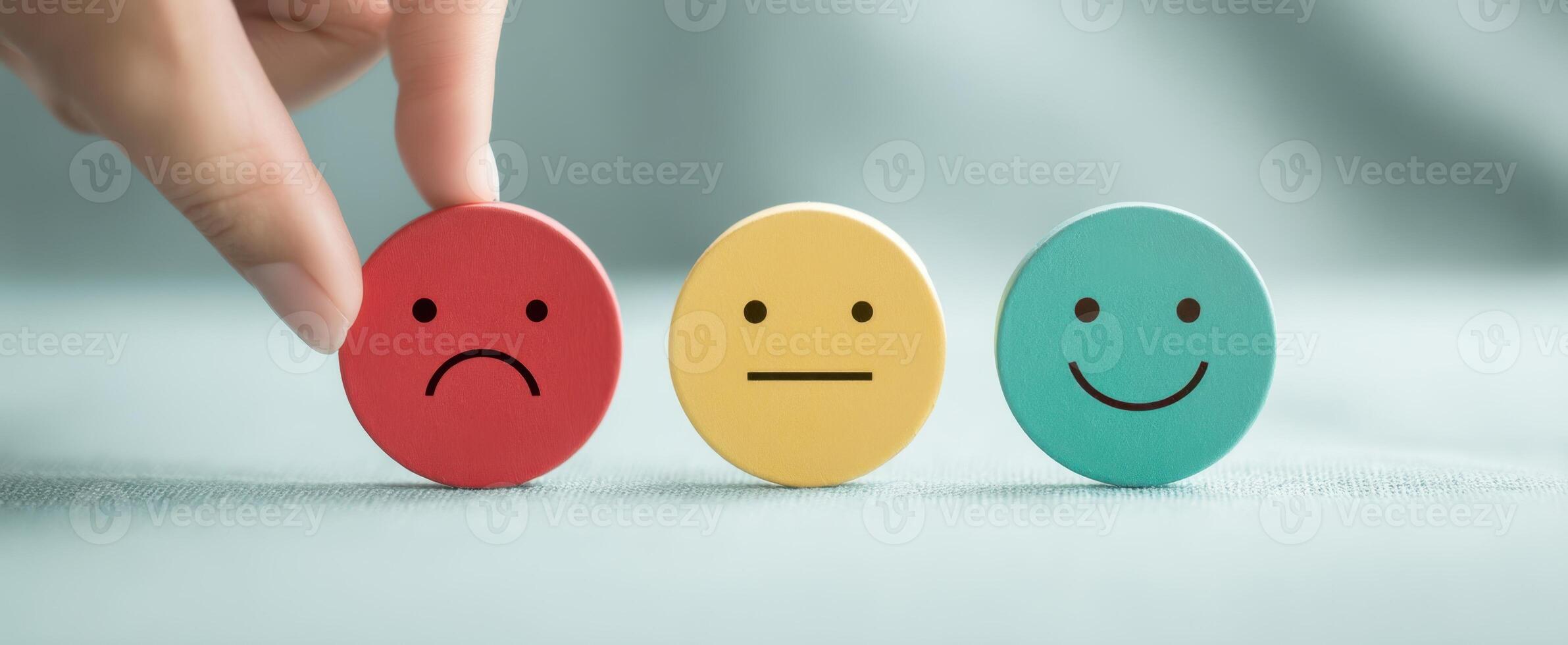 The hand selecting emotional response among color-coded expression icons photo