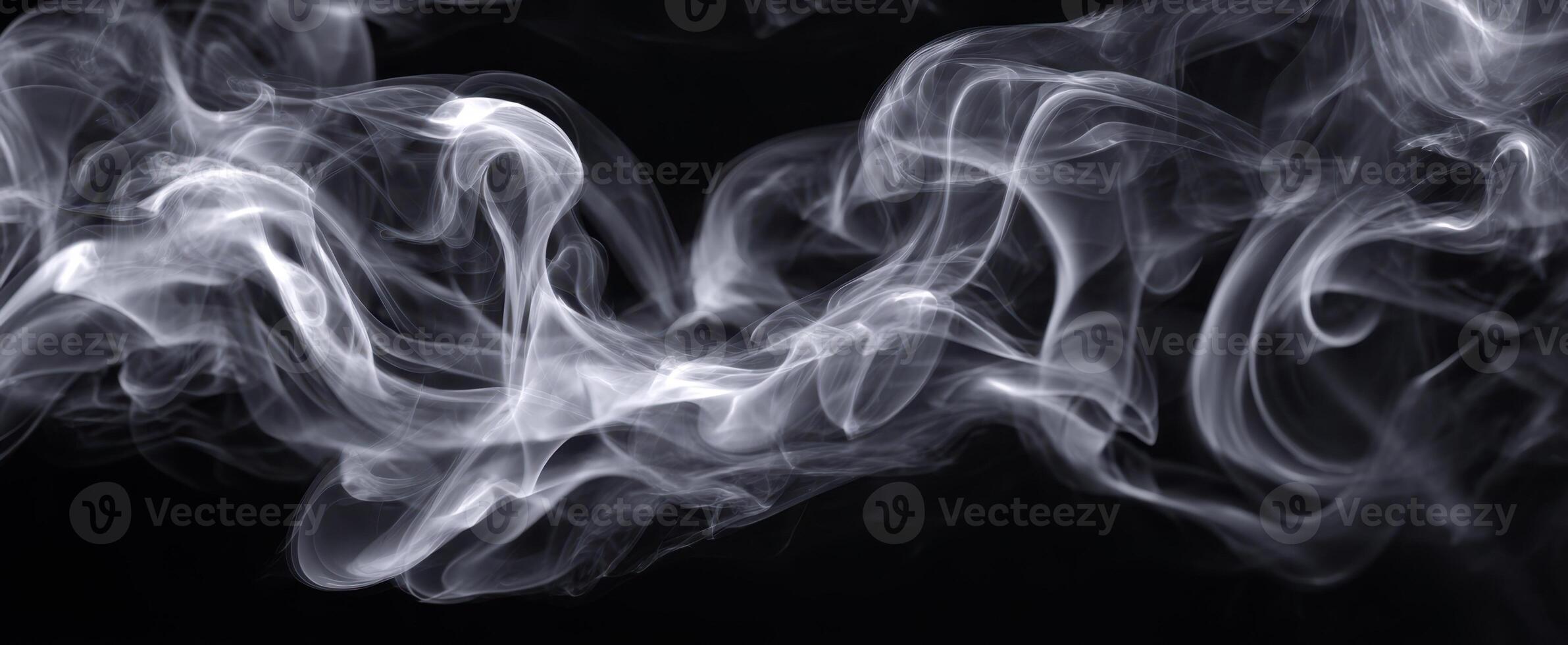 The elegant dance of smoke against a dark background in abstract form. photo