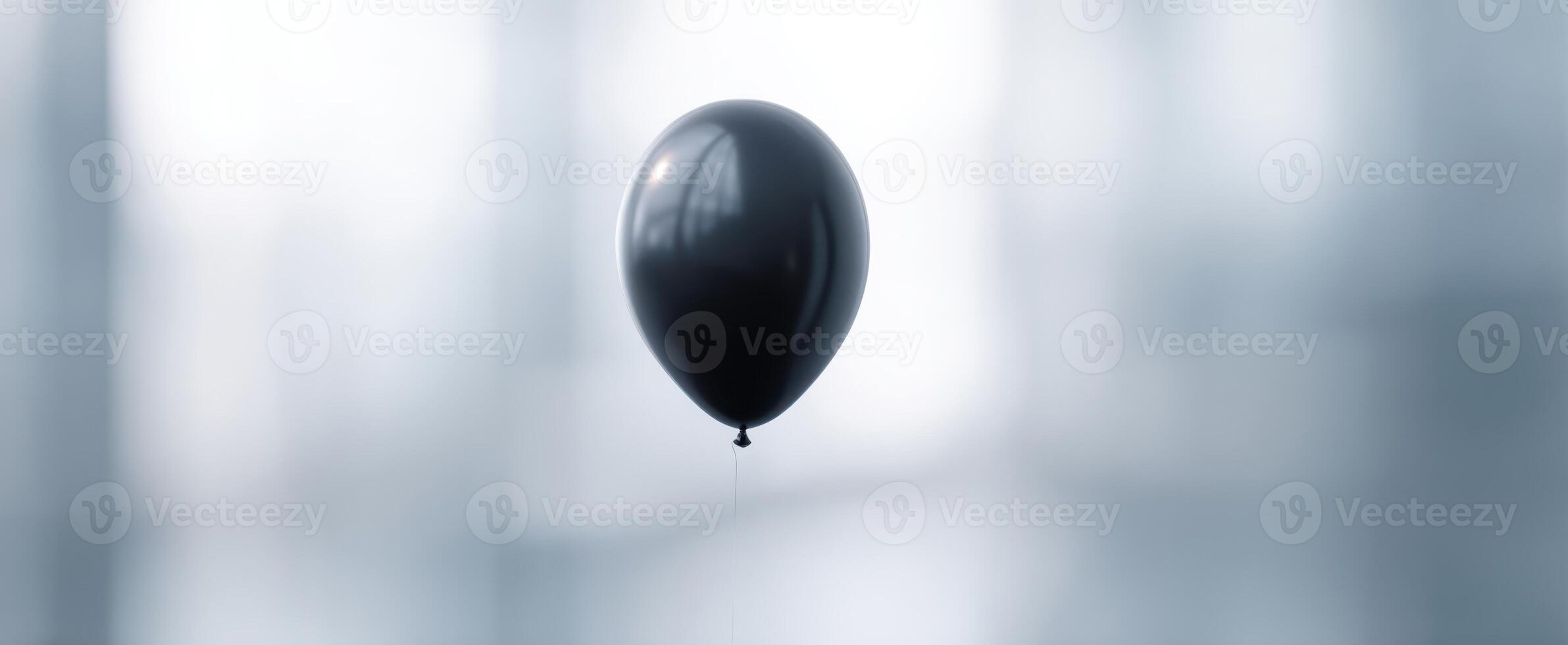 The Black Balloon Floating Elegantly in a Soft, Minimalist Background photo