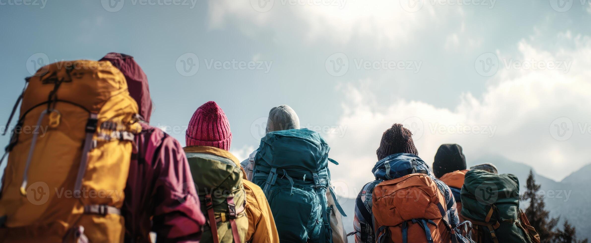 The group of hikers ascending towards a majestic mountain landscape. photo