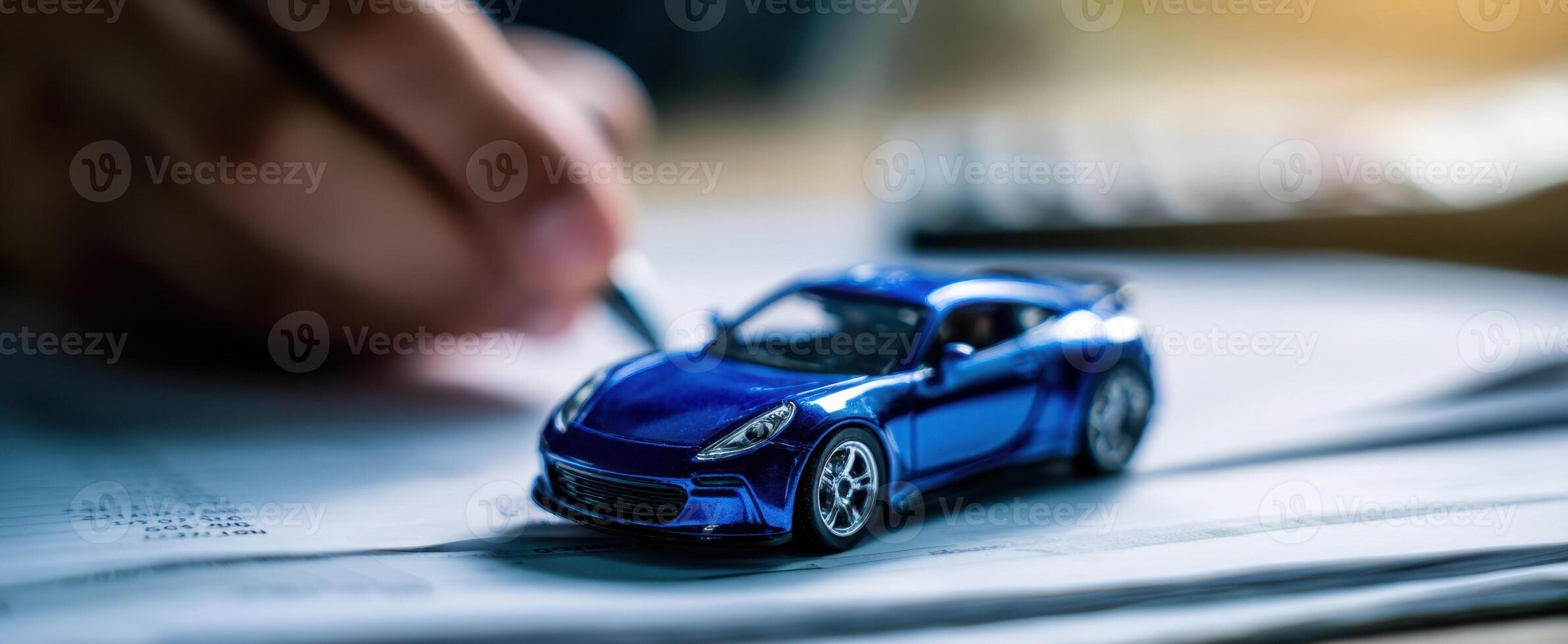 The blue model car on paperwork with a hand writing notes. photo