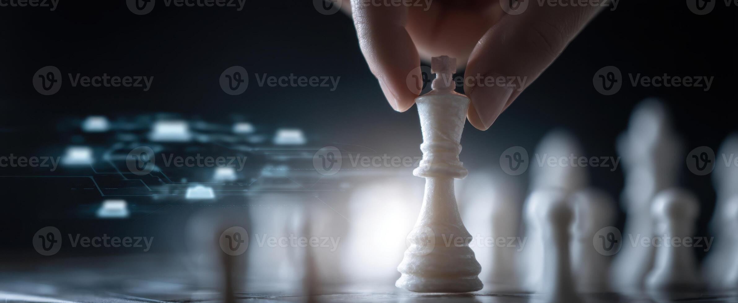 The hand moving the king piece in a digital chess game setting. photo