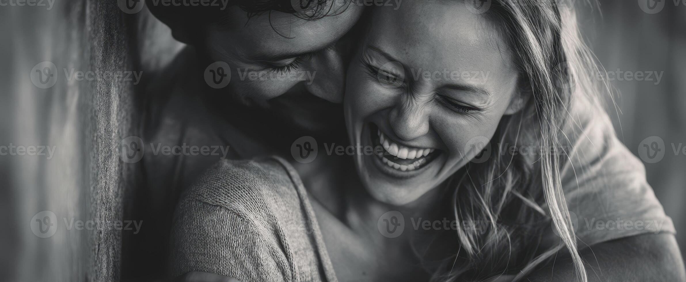 The joyful couple sharing laughter in a candid moment of intimacy. photo
