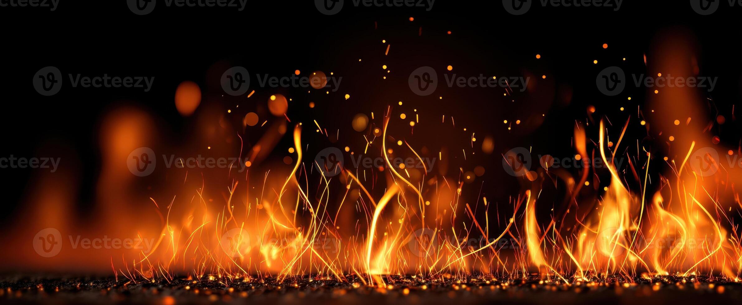 The Dynamic Flames Dancing Against a Dark Background in Radiant Colors photo