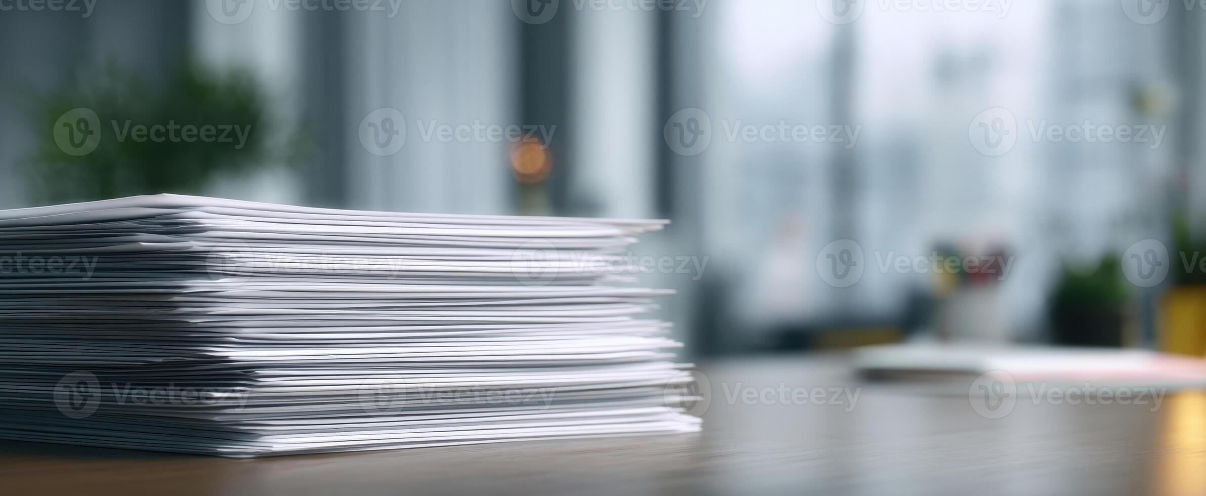 The stack of paperwork on a modern office desk with blurred background. photo