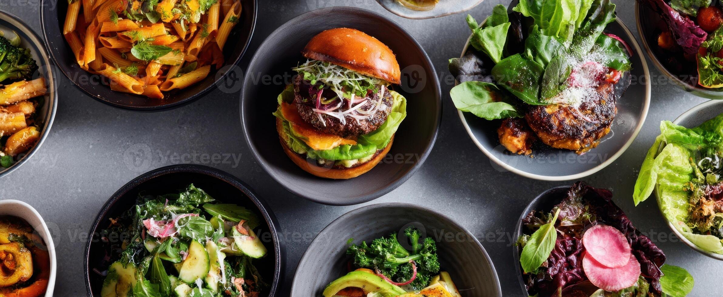 The colorful arrangement of delicious salads and a gourmet burger on display. photo
