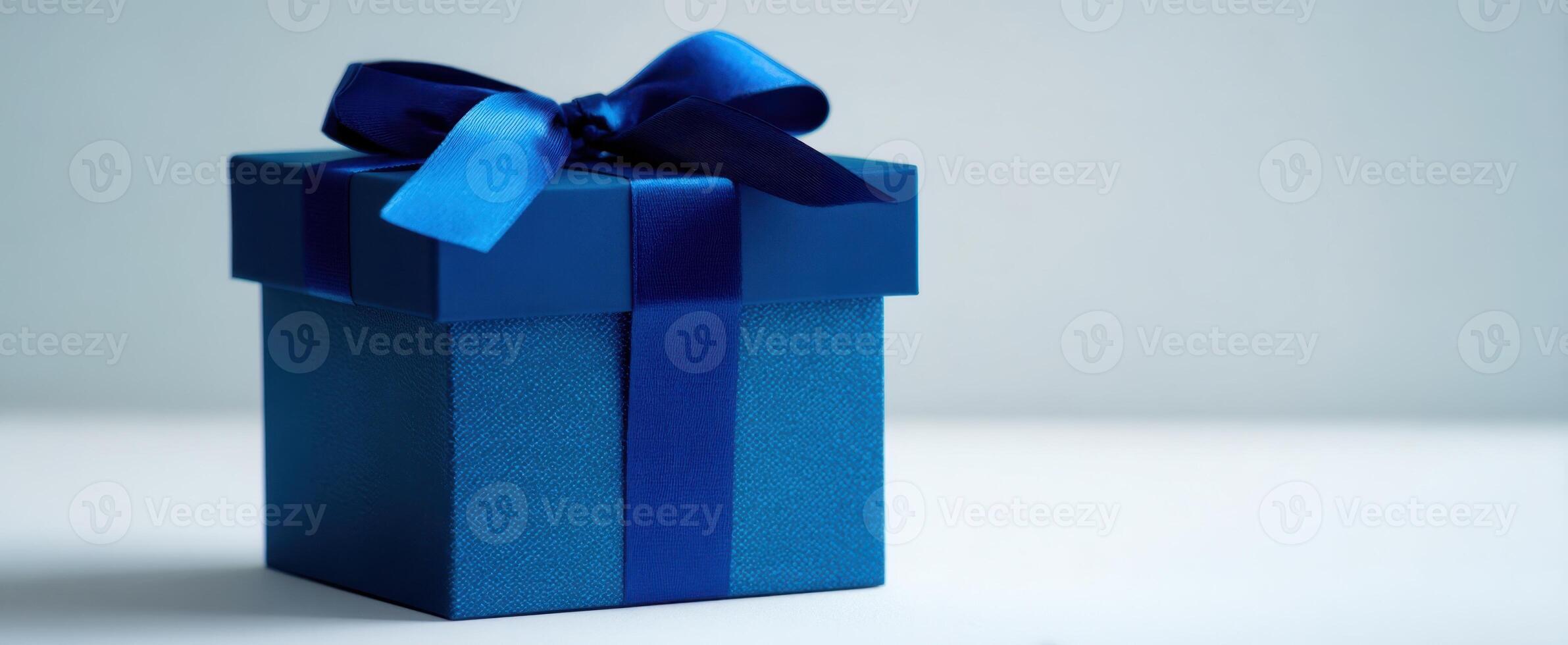 The beautiful blue gift box with a ribbon waiting for a special occasion. photo