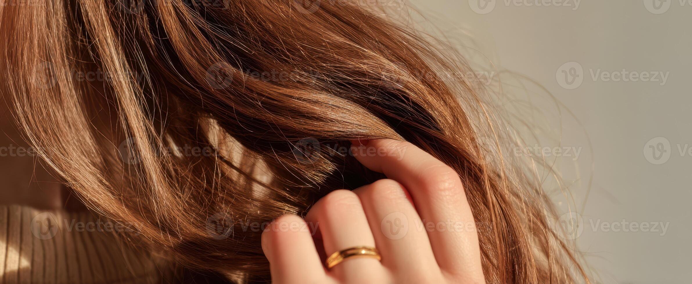 The elegant touch of a woman's hand playing with her flowing hair. photo