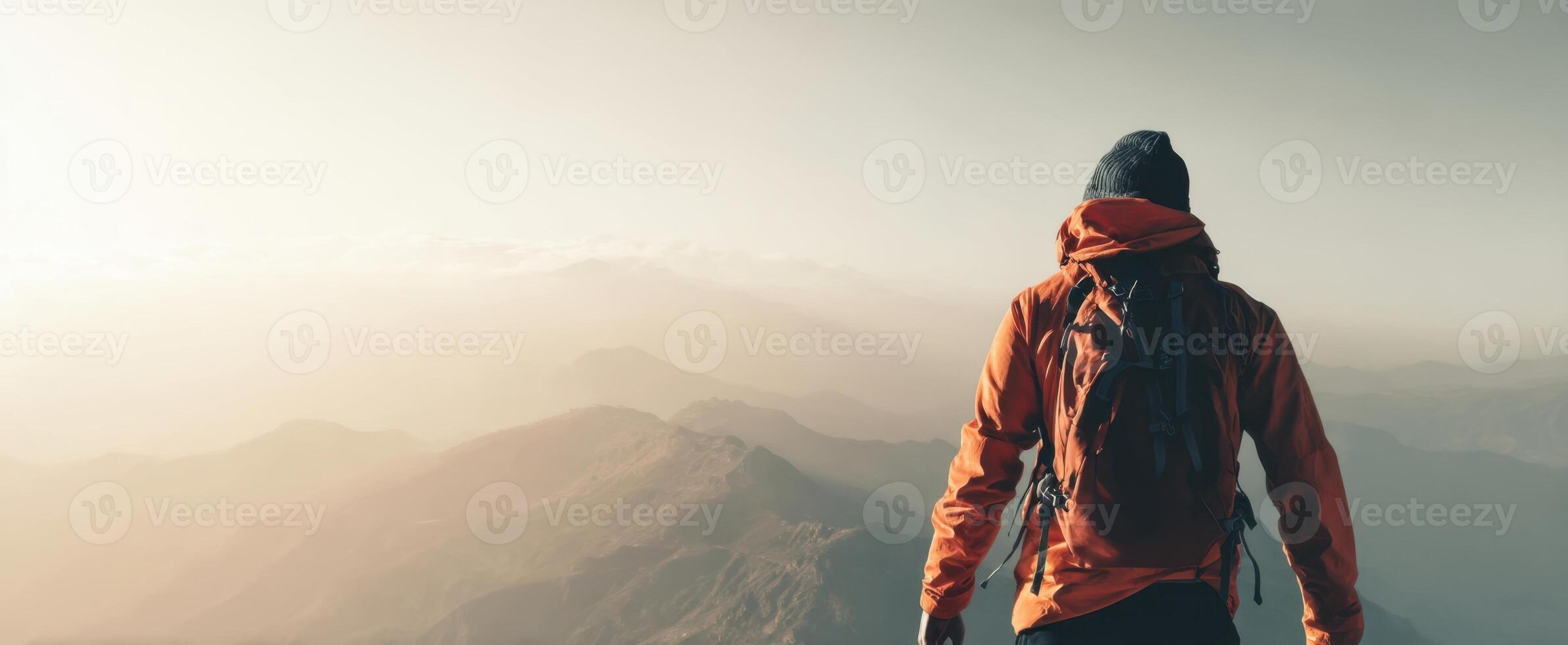 The adventurous hiker gazing at breathtaking mountain vistas during sunrise. photo