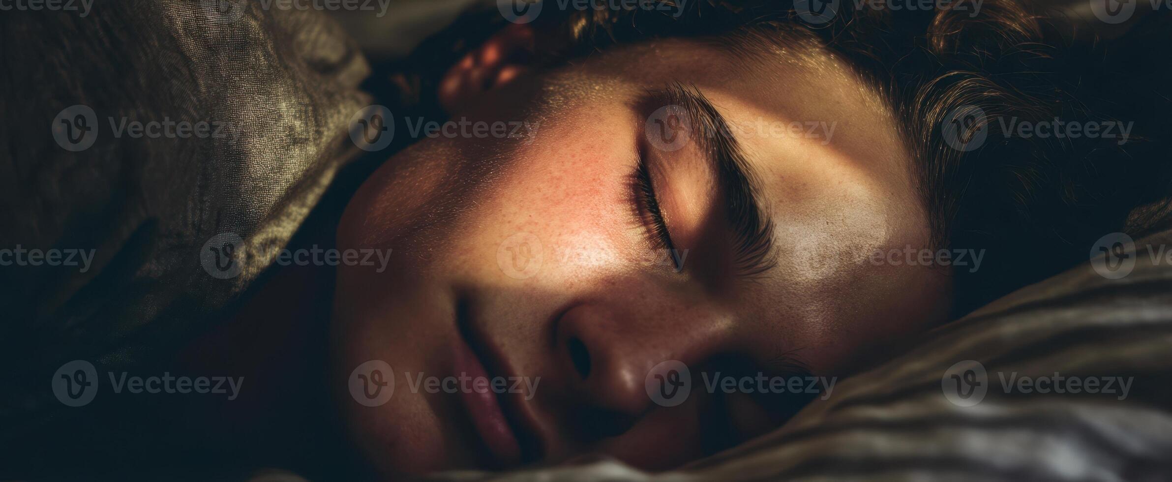 The peaceful sleeping teenager bathed in warm morning sunlight. photo