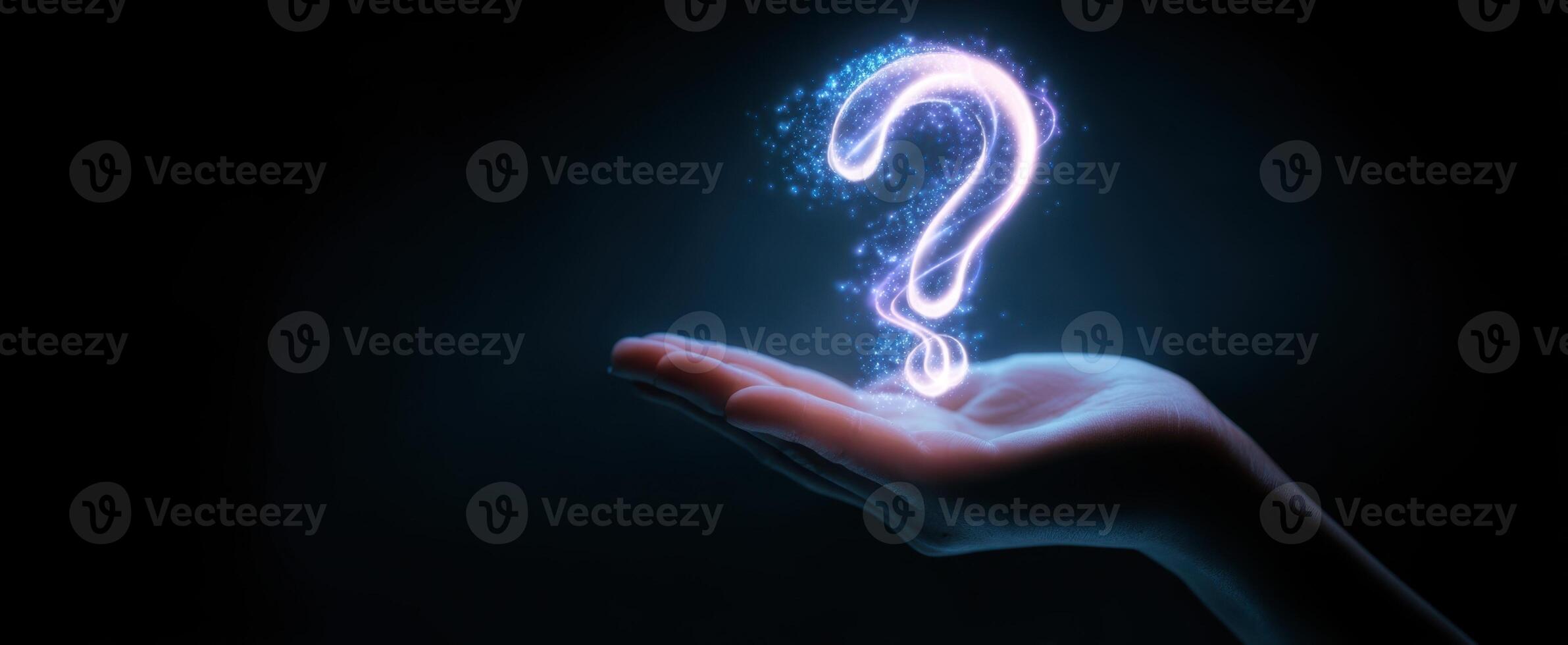The Hand Holding a Glowing Question Mark in a Dark Environment photo