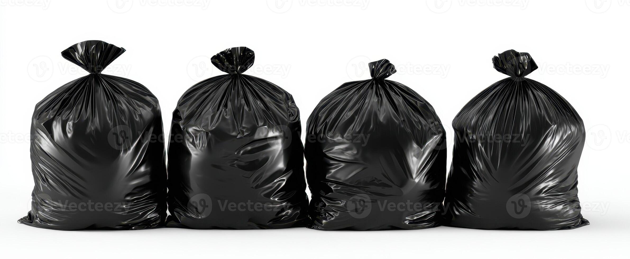 The four black garbage bags stacked neatly in a row on white background photo