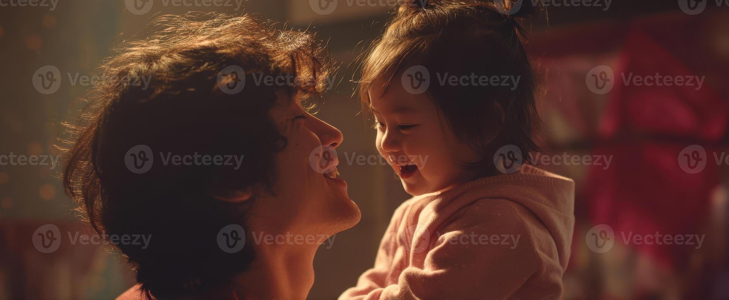 The joyful bond between a father and his laughing daughter in a warm setting photo