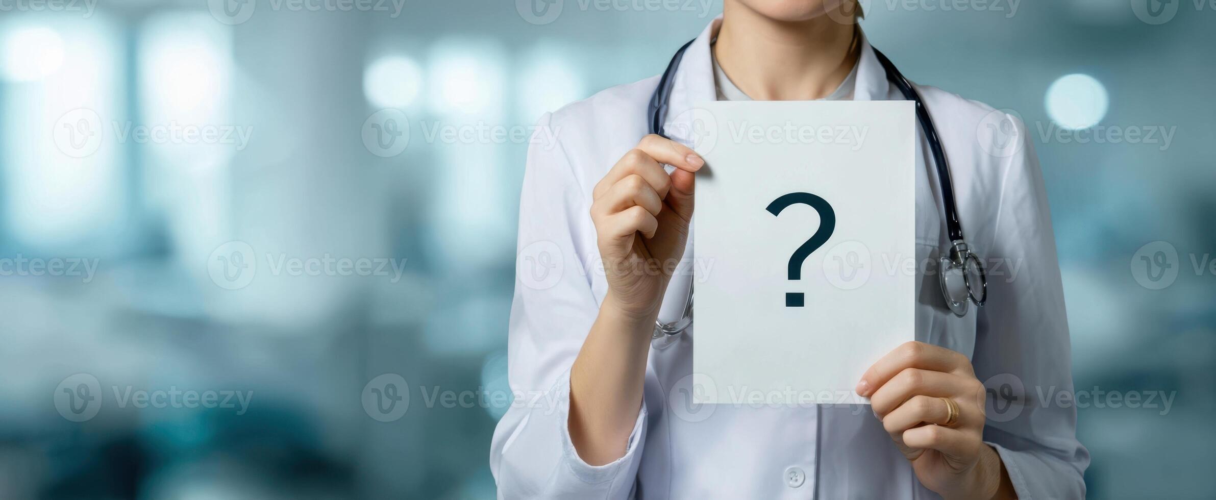 The doctor holding a sign with a question mark in a healthcare setting. photo