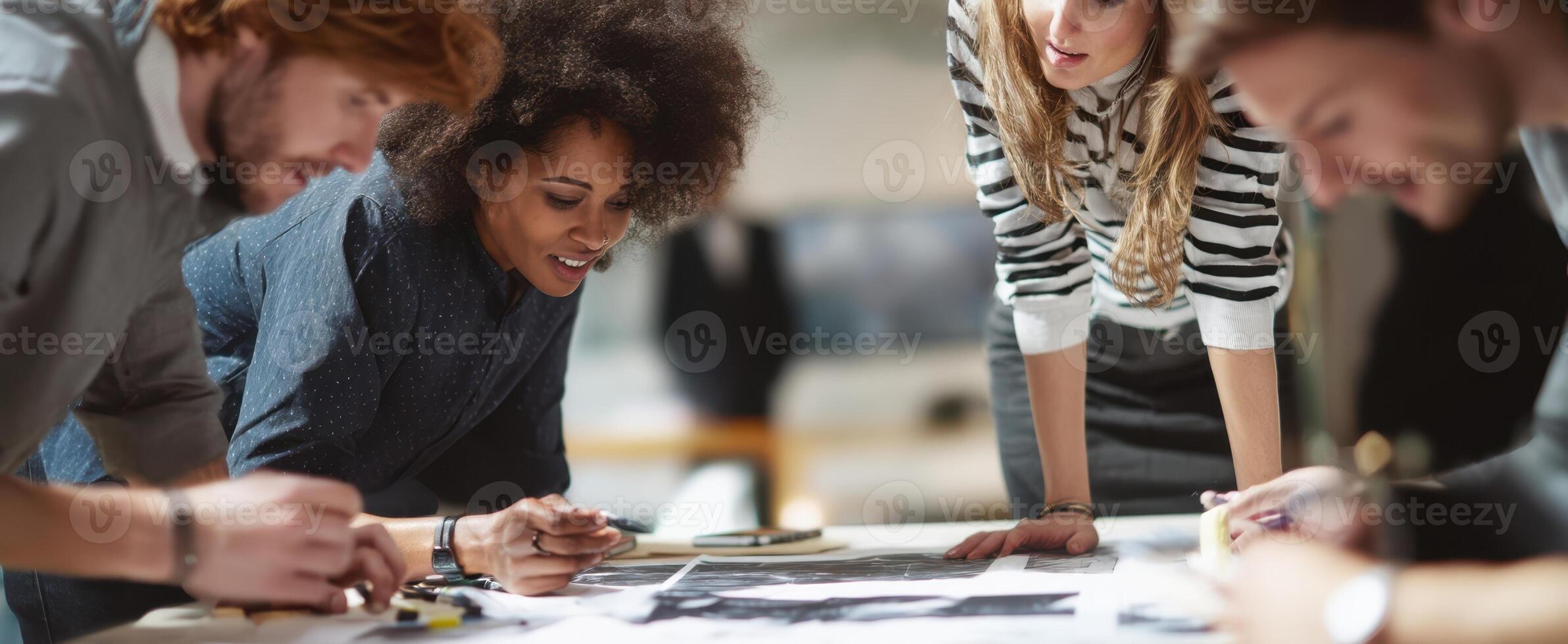 The diverse group brainstorming ideas and collaborating on a creative project. photo