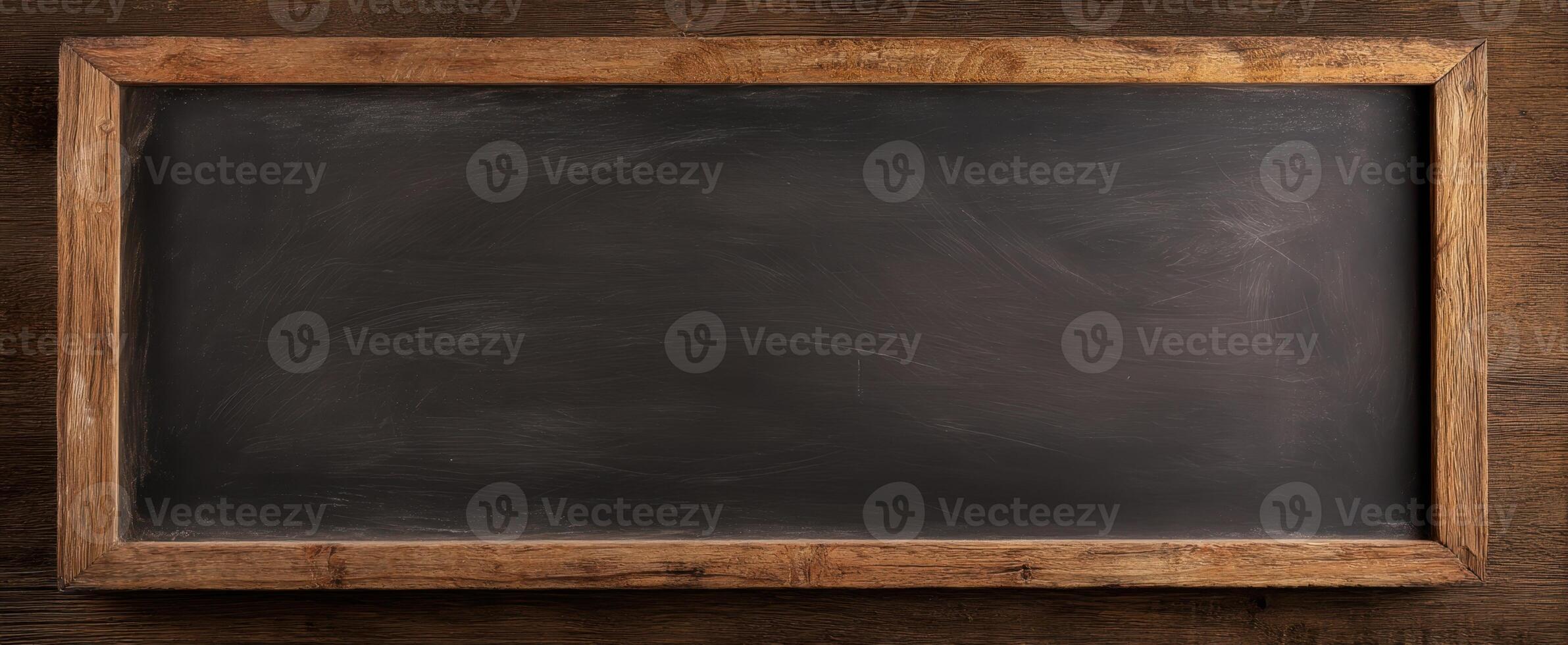 The empty chalkboard framed in rustic wood, perfect for creative messaging. photo