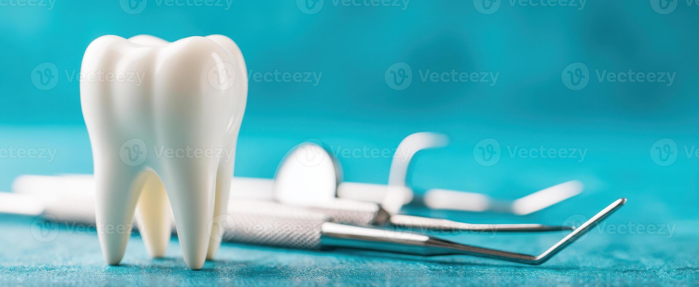 The dental tool setup with a prominent tooth model on a blue background. photo