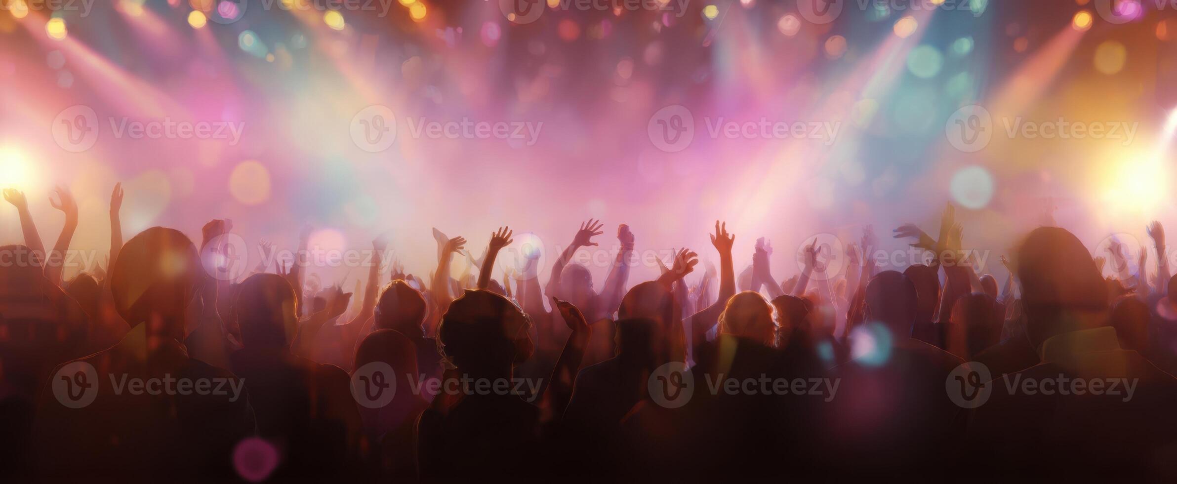 The vibrant and energetic crowd enjoying a live concert under dazzling lights. photo