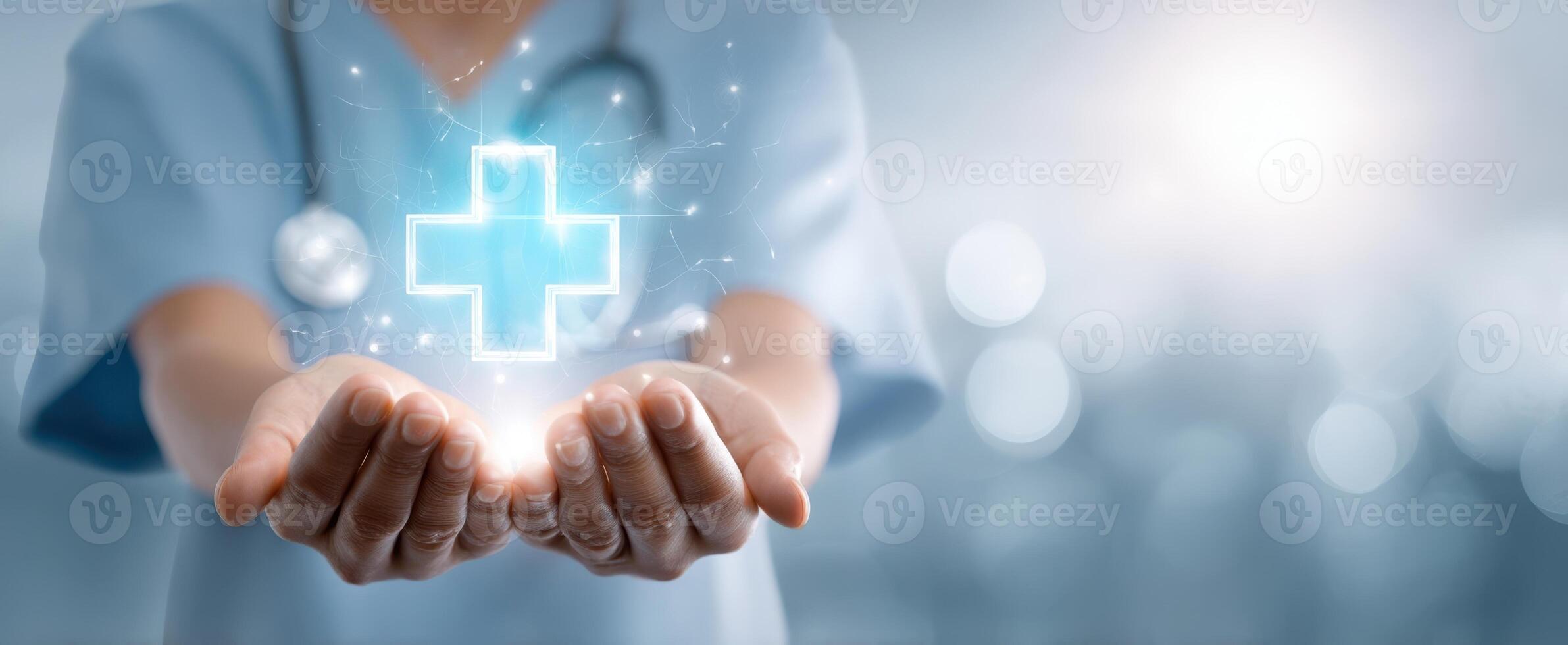The doctor presenting a glowing healthcare symbol in hands. photo