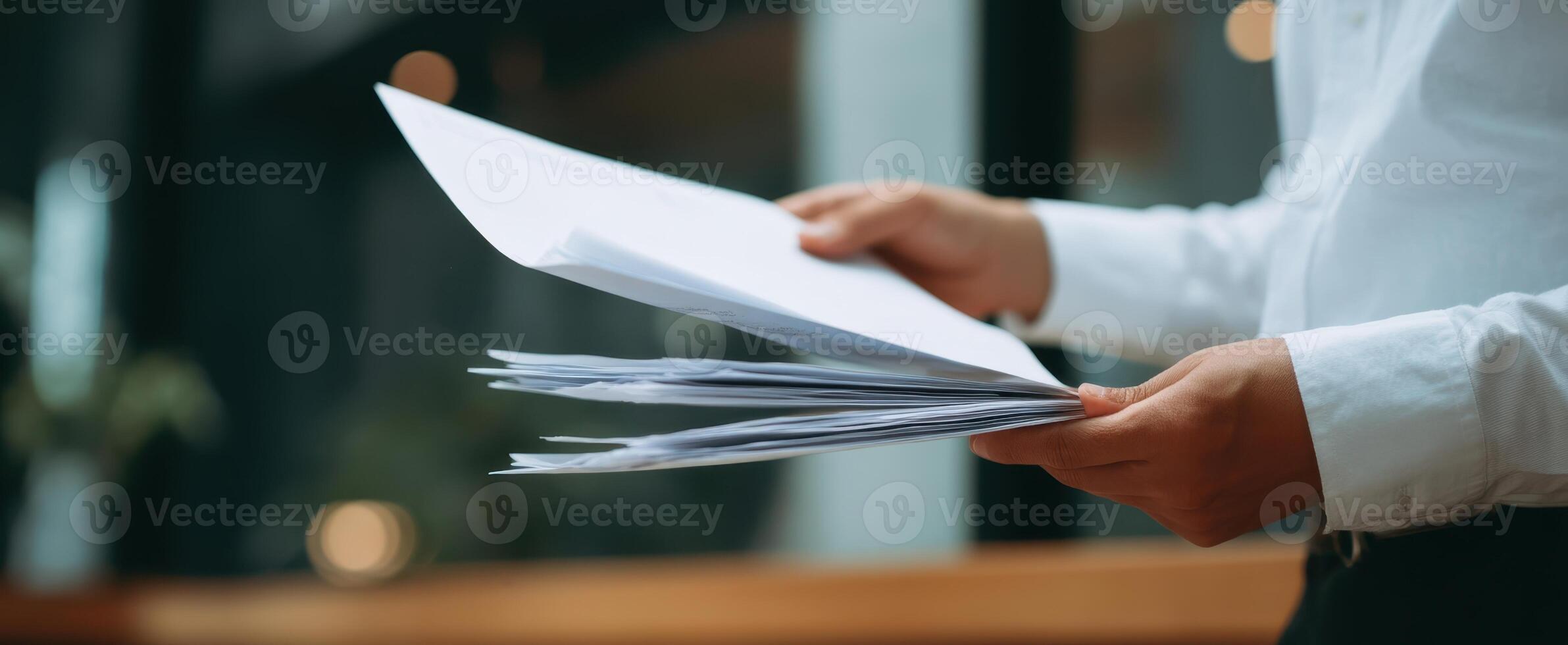The hands holding important papers in a modern office environment photo