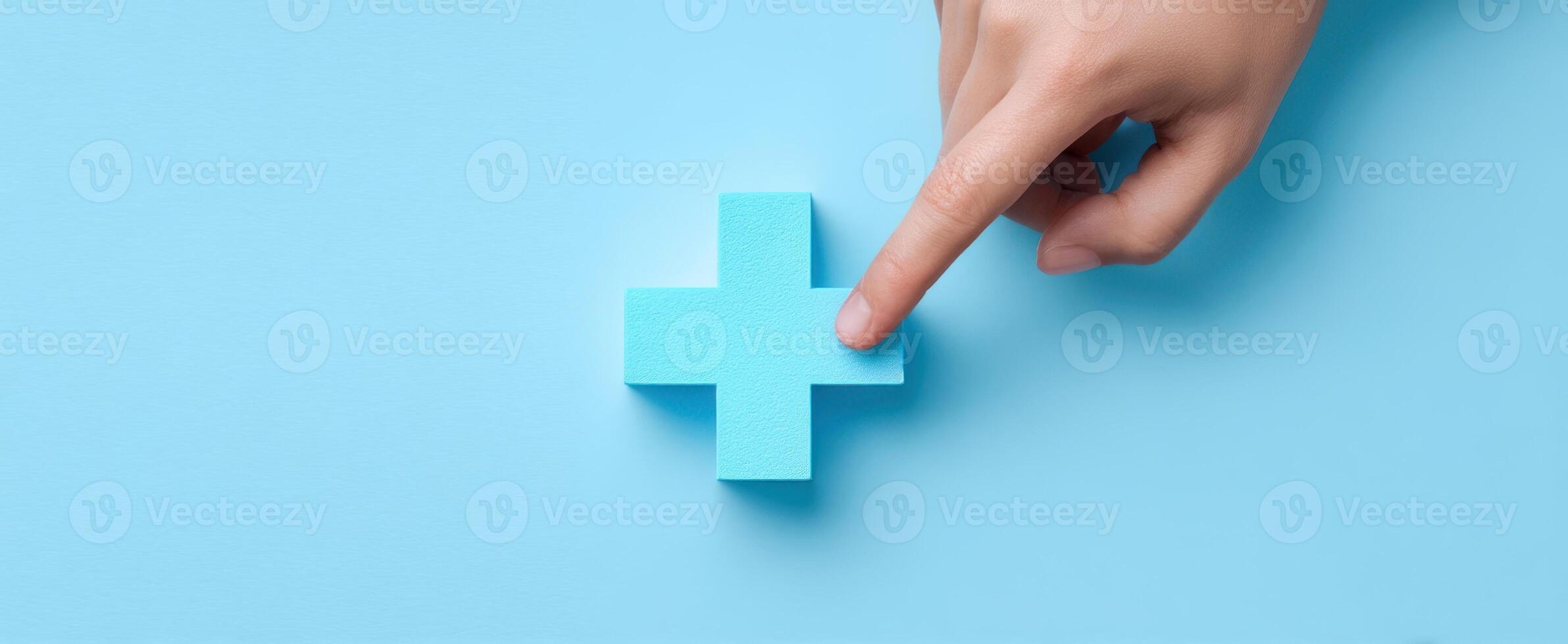 The hand touching a blue plus symbol on a pastel background. photo