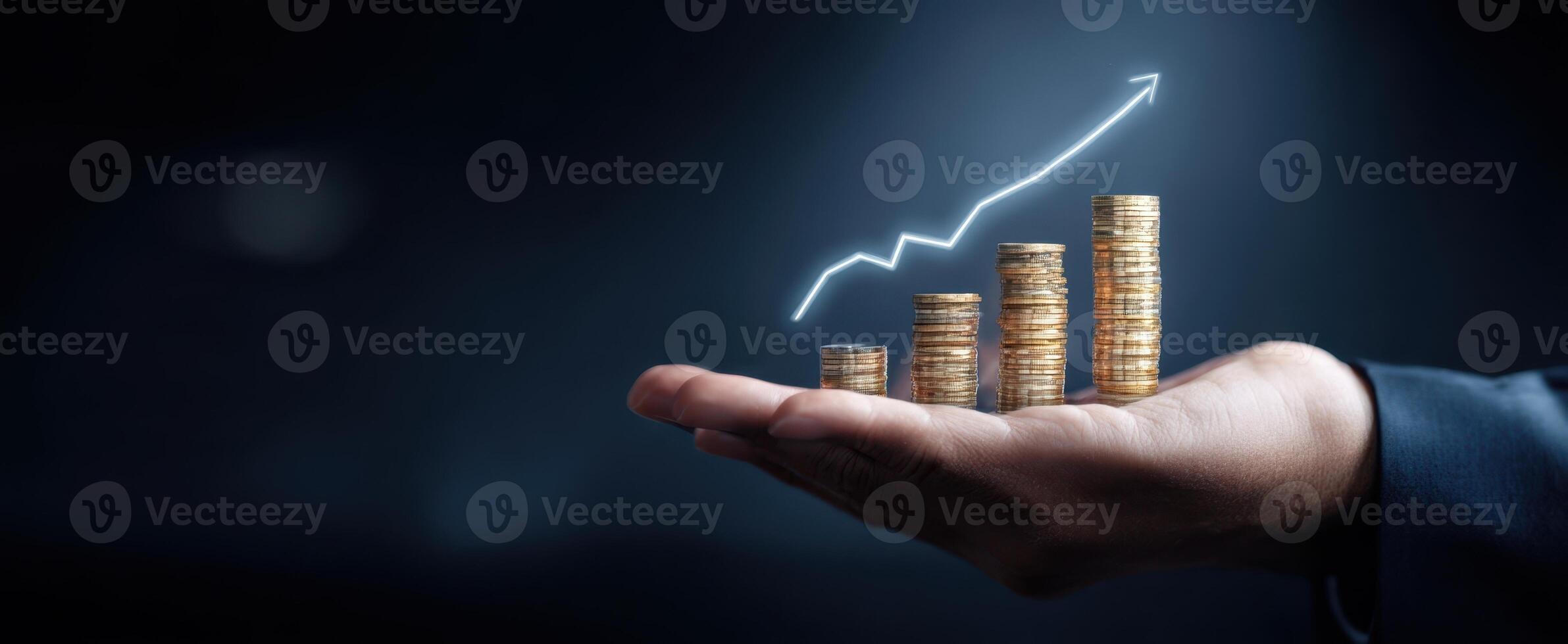 The hand supporting a growing stack of coins with upward trend graph photo