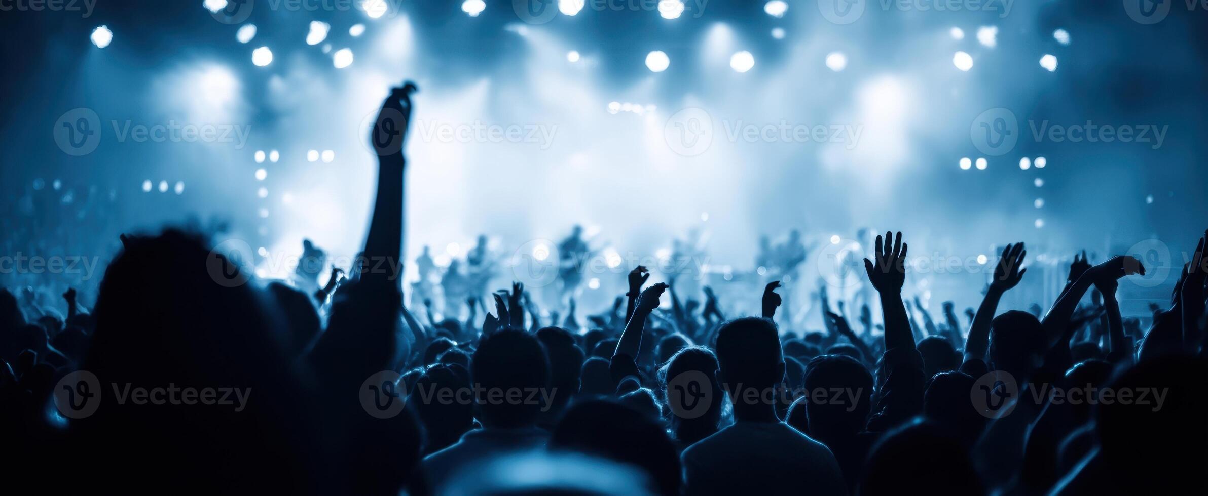 The electrifying atmosphere of a concert filled with enthusiastic fans. photo