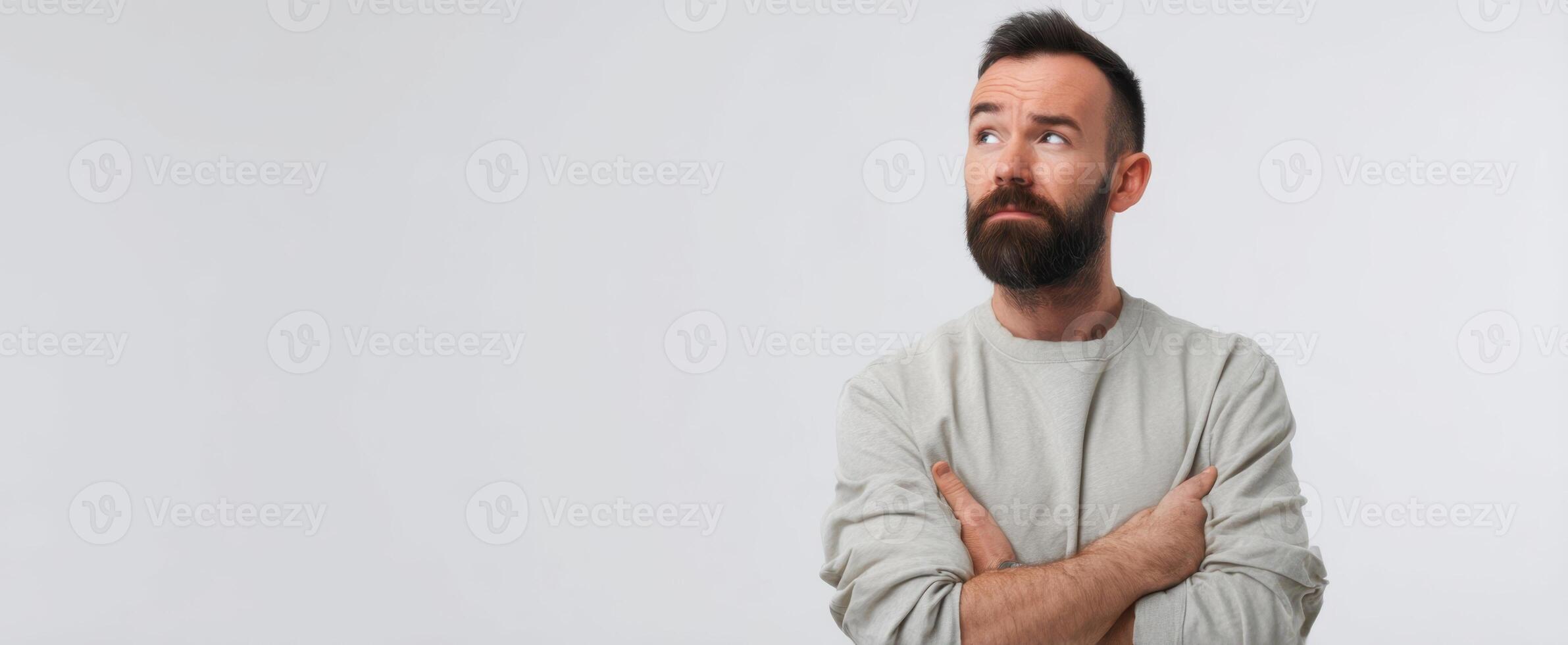 The thoughtful man with arms crossed contemplating life's deeper questions. photo