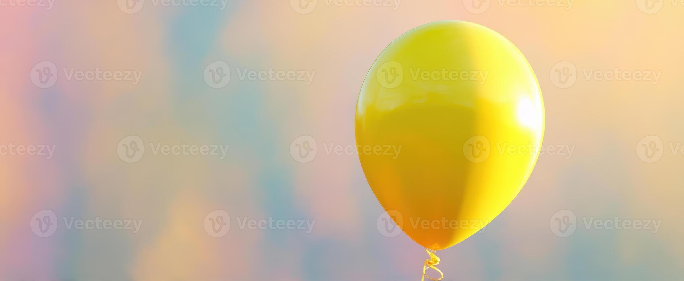 The bright yellow balloon floating against a dreamy colorful background. photo